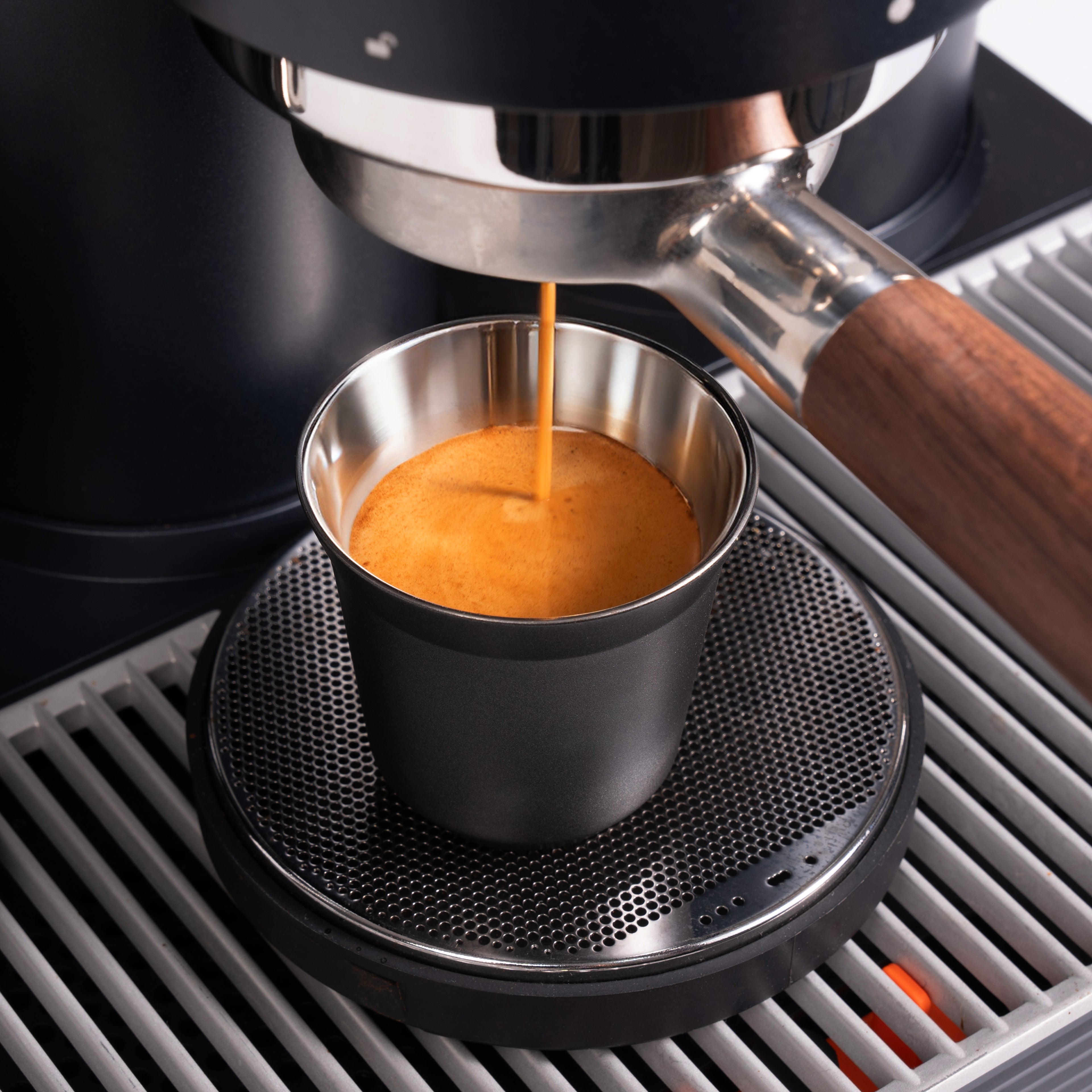 Espresso pouring into a Meraki double-walled cup